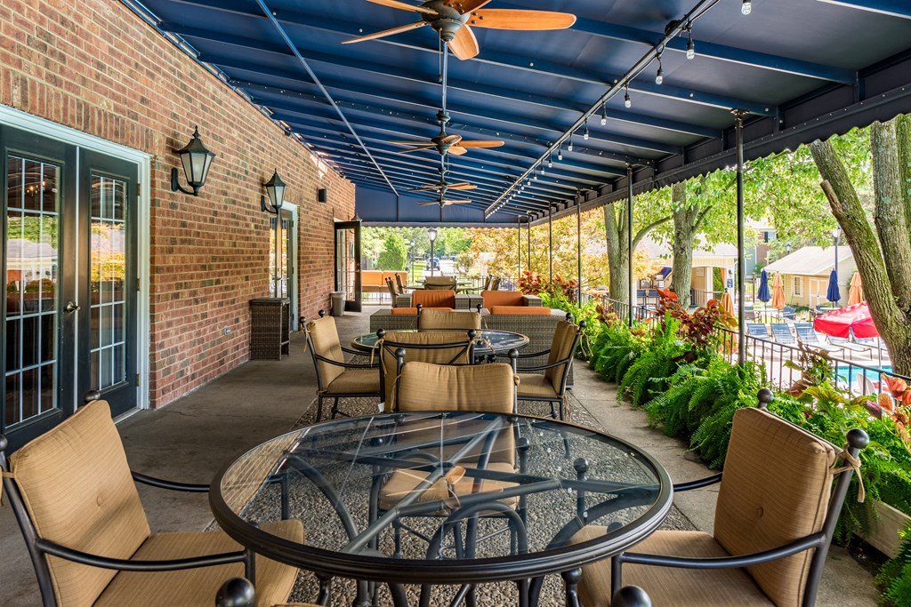 Patio with tables and chairs and a blue ceiling at Indian Creek Apartments, Cincinnati, OH, 45236