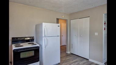 a kitchen with a white refrigerator freezer next to a stove top oven