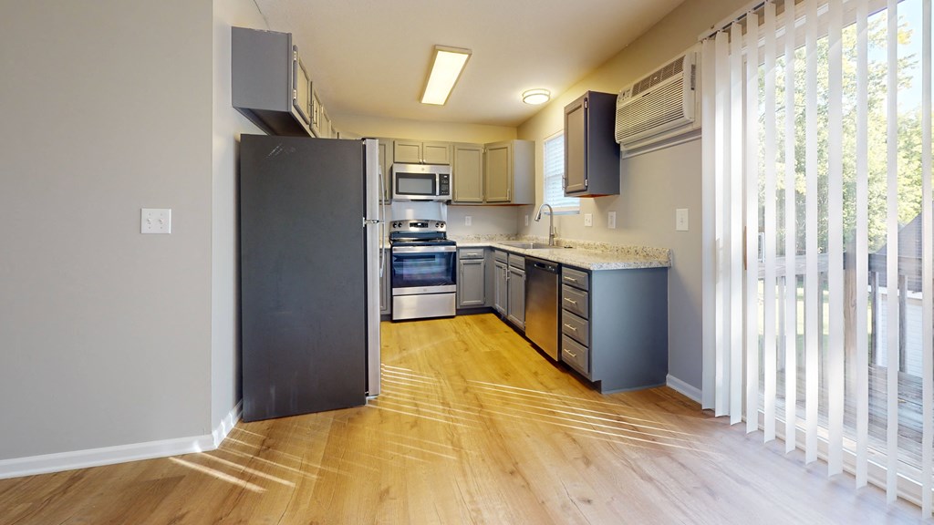 a kitchen with stainless steel appliances and a large window
