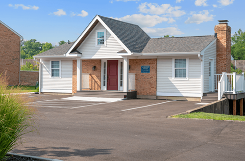 White townehome with a red door and a black asphalt driveway at Galbraith Pointe Apartments and Townhomes, Cincinnati,  45231