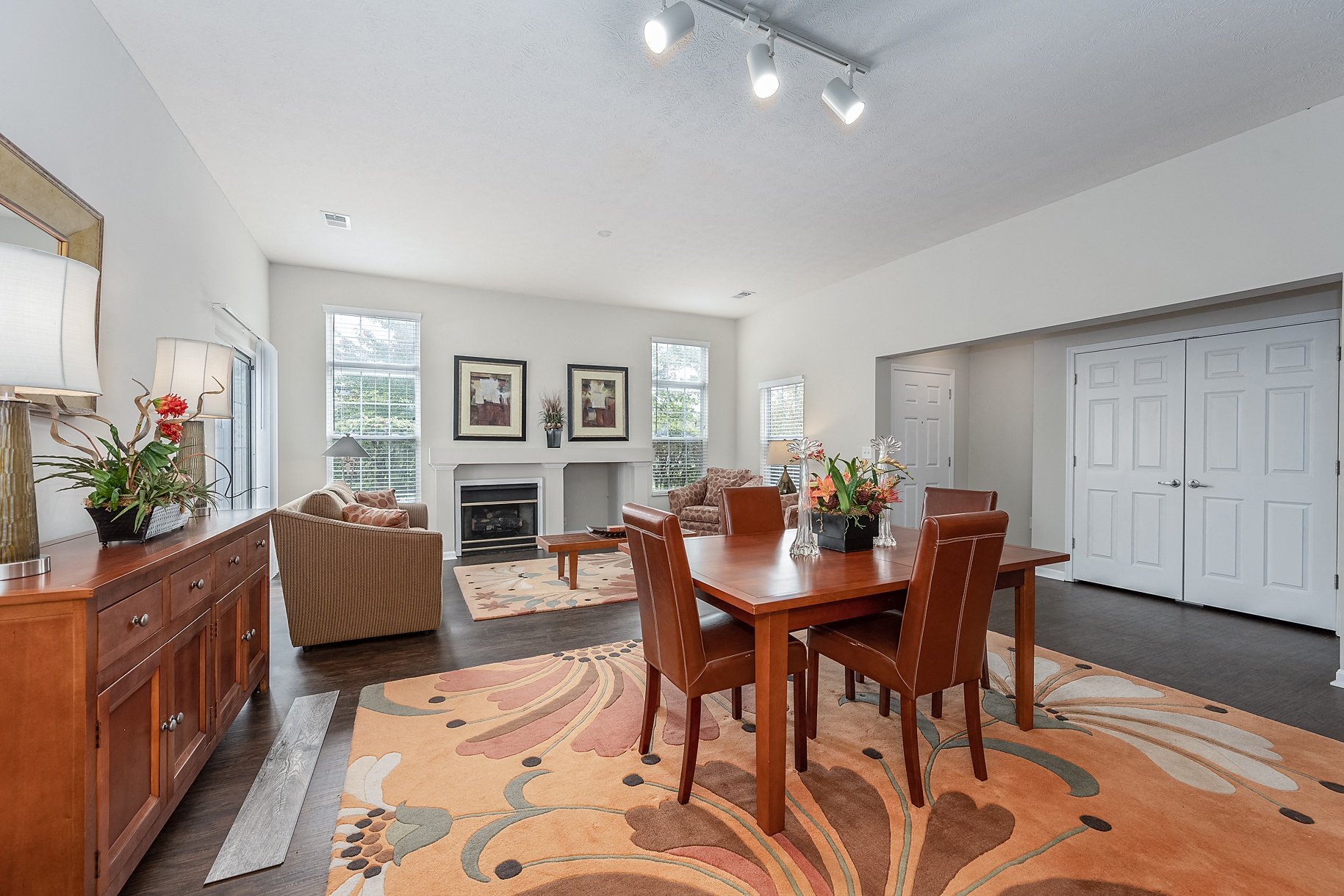 a living room and dining room with a table and chairs