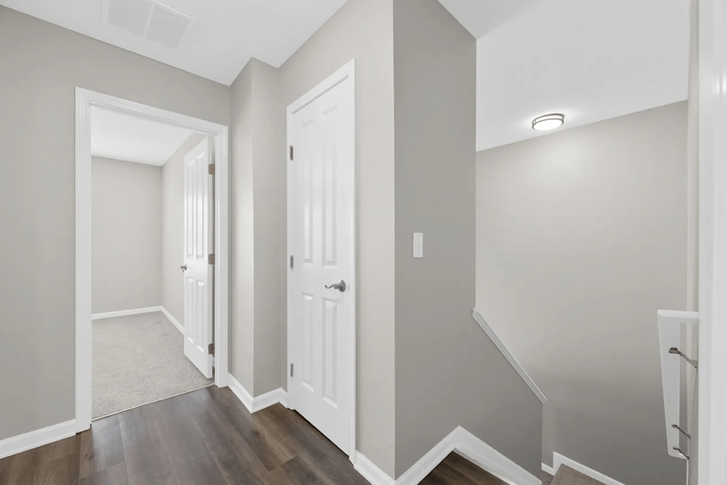 a renovated living room and hallway with a door to a closet at Traditions at Slate Ridge, Ohio