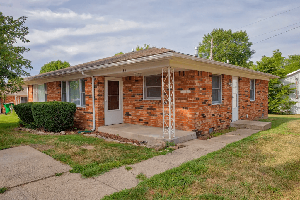 a small brick house with a porch at Stonebrook of Franklin, Franklin