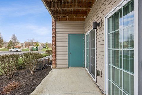 Covered patio entry with sliding glass door at Fieldstone Apartments, Beavercreek, OH