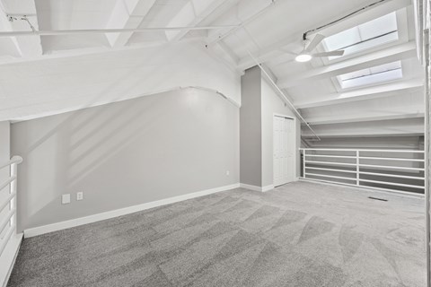 Loft space with exposed beams and skylights at The Landing Apartments, Dayton, OH