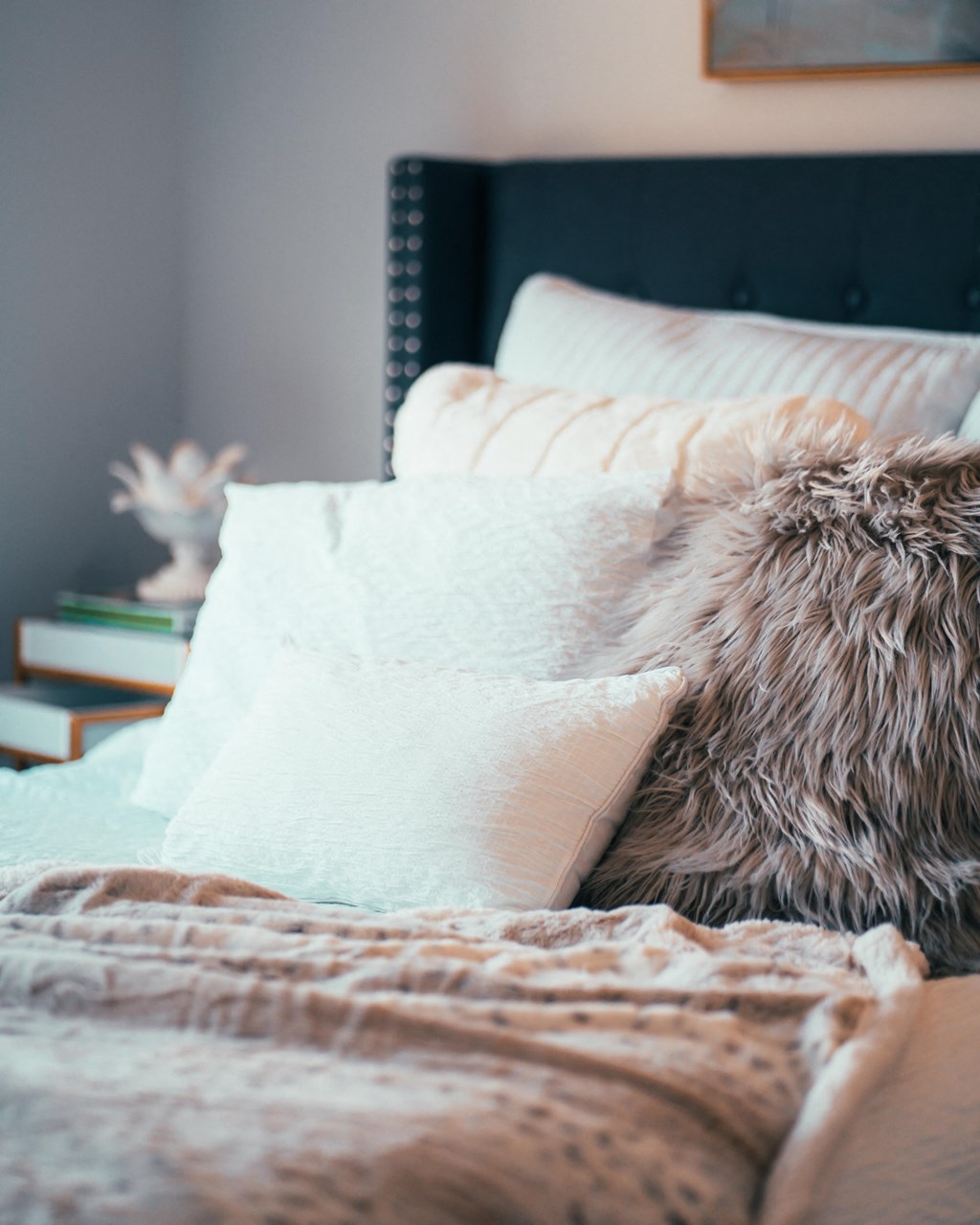 a bed with pillows and a blanket on it