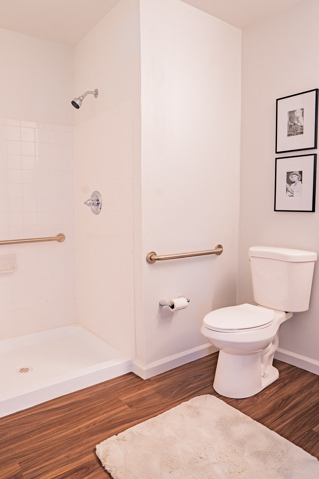a white bathroom with a toilet and a shower