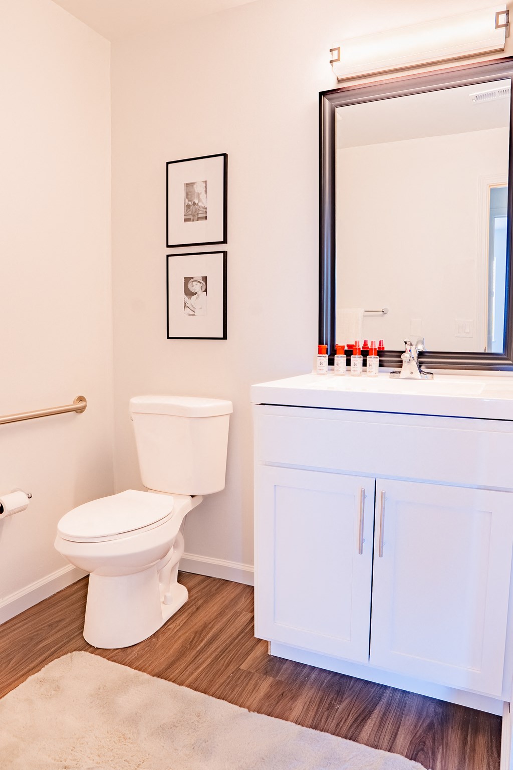 a bathroom with a toilet and a sink and a mirror