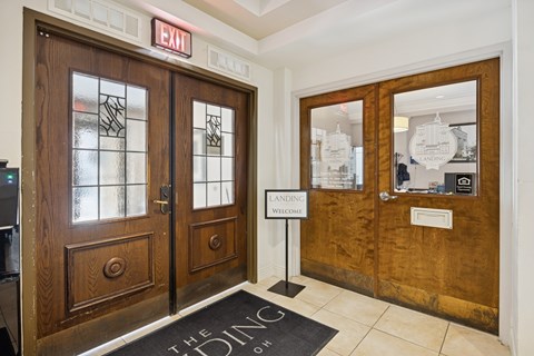A brown door with a glass window and a sign that says "EXIT" above it.