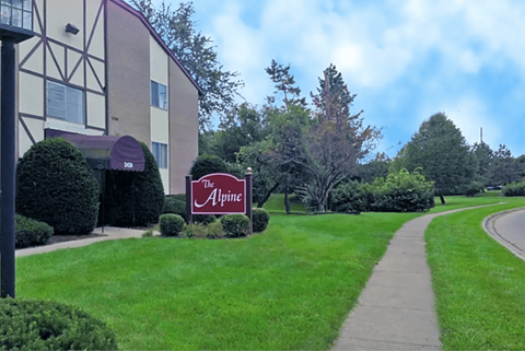 A sign for The Alpine is in front of a building at The Alpine Apartments, Ohio, 45429