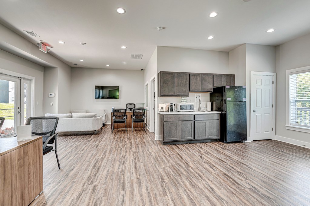 A modern kitchen with a refrigerator, cabinets, and a microwave. at The Apex, Cincinnati