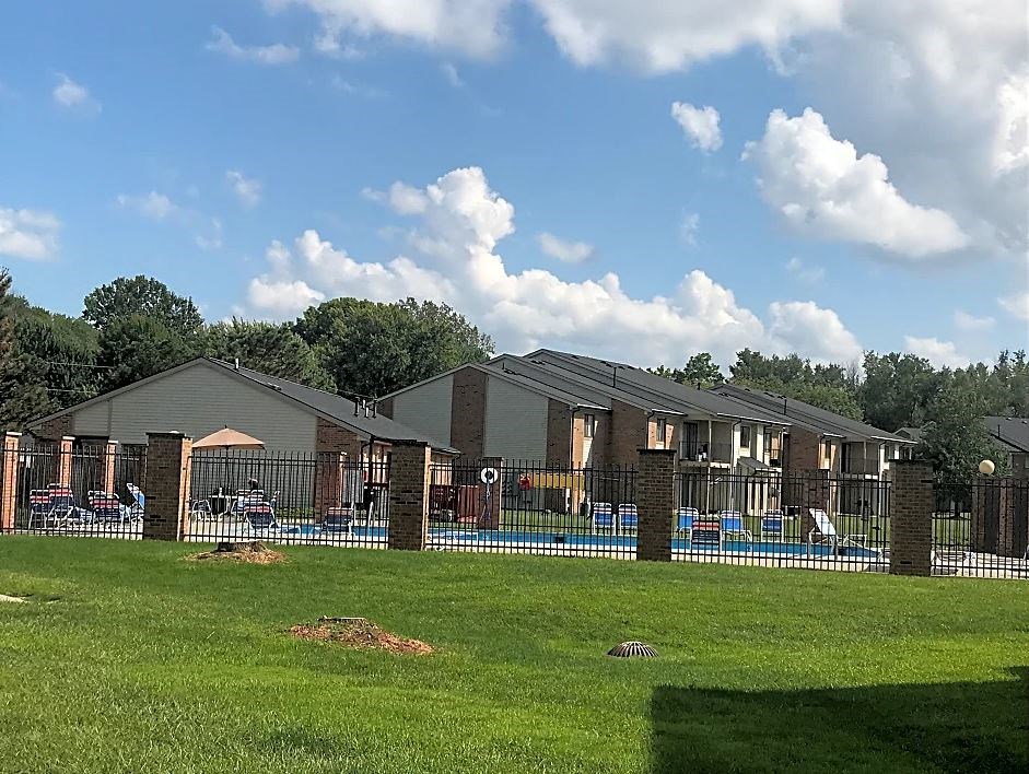 a house with a fenced in yard and a swimming pool