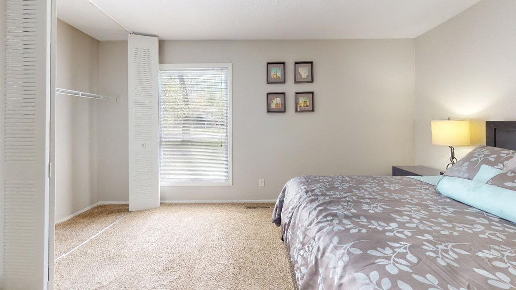Bedroom with a bed and a closet at Summit at Keystone, Indianapolis, IN