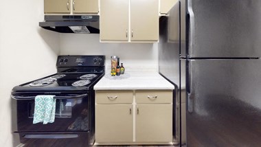 a kitchen with a stove top oven next to a refrigerator