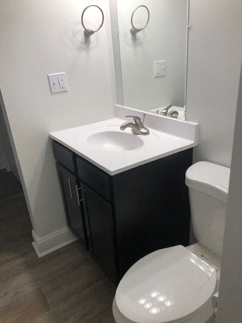 a bathroom with a sink toilet and a mirror