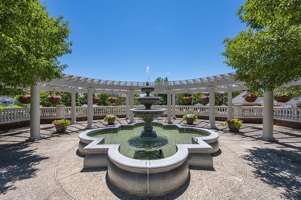 a fountain in the center of a park with a pergola at Bishops Gate, Cincinnati