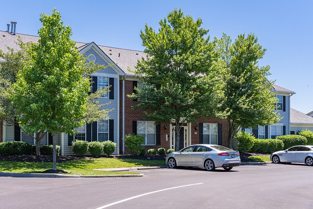 an apartment building with two cars parked in front of it at Bishops Gate, Ohio