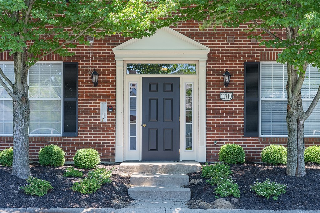 a red brick house with a black door