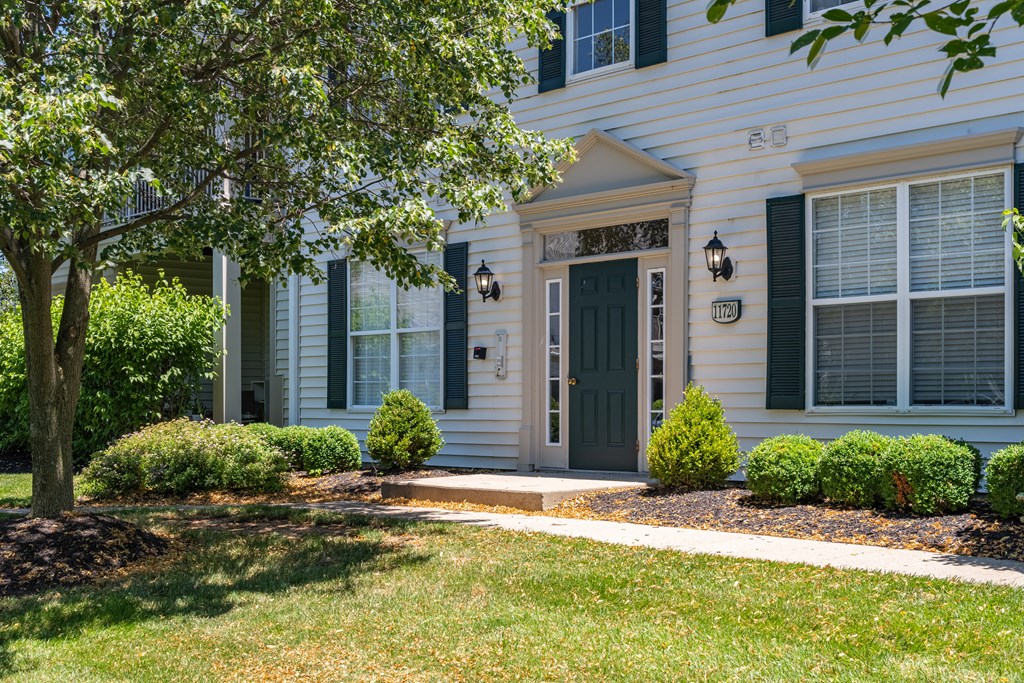 the front of a house with a green door