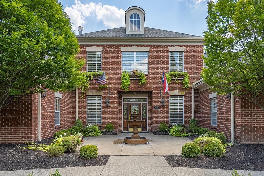 a front view of a brick building with a fountain at Bishops Gate, Cincinnati, OH, 45249