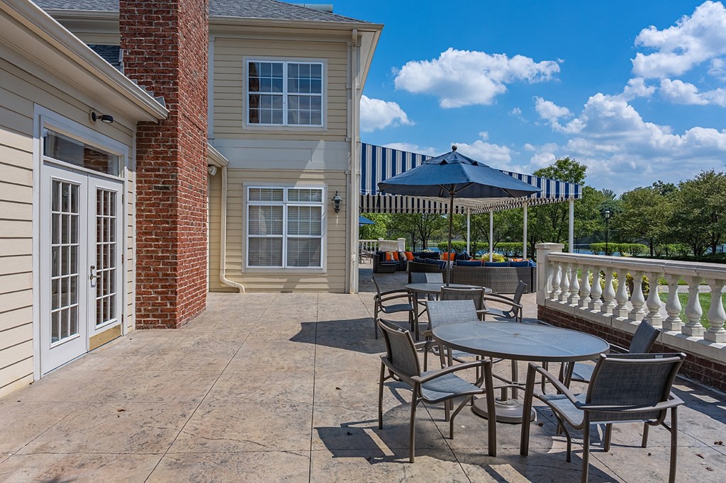 the preserve at ballantyne commons patio with tables and chairs and a white house