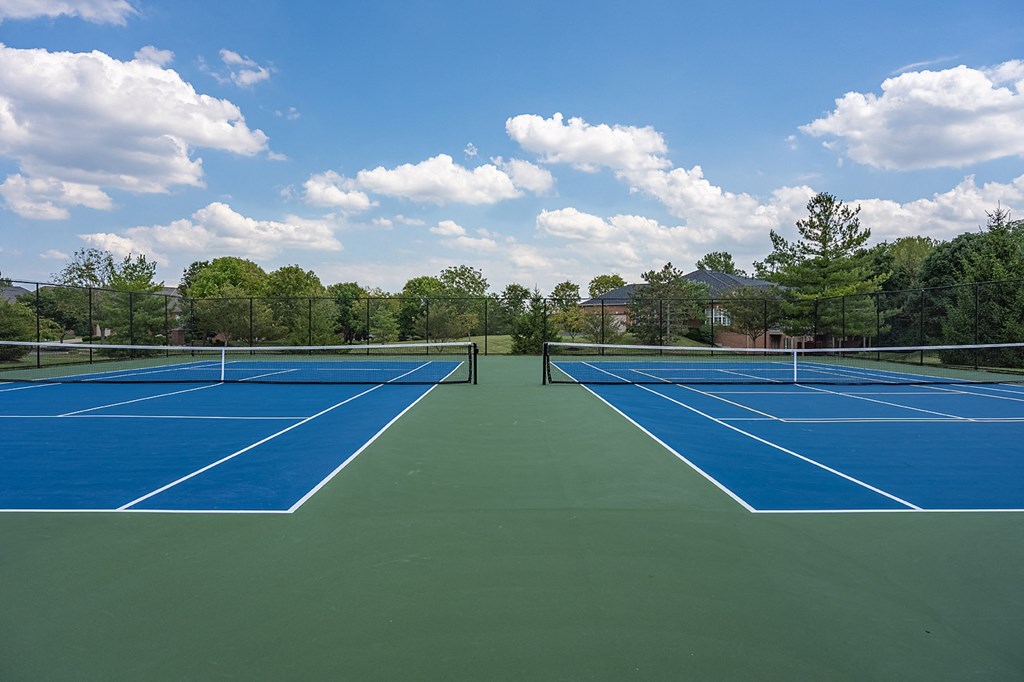 two tennis courts with blue and green surfaces on a sunny day at Bishops Gate, Cincinnati, 45249