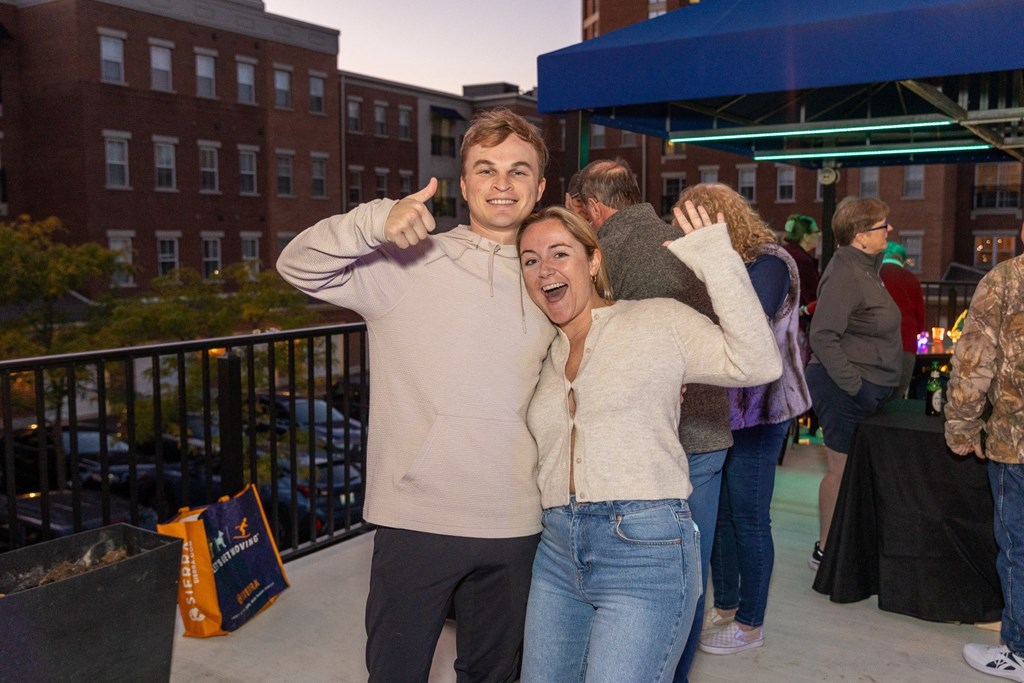 a man and woman posing for a picture at a party