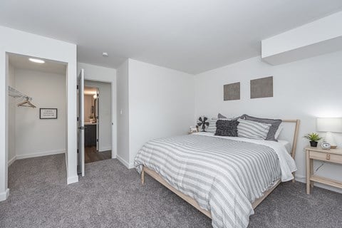 Bedroom with cozy bed at Bloomfield Apartments, Dayton, Ohio