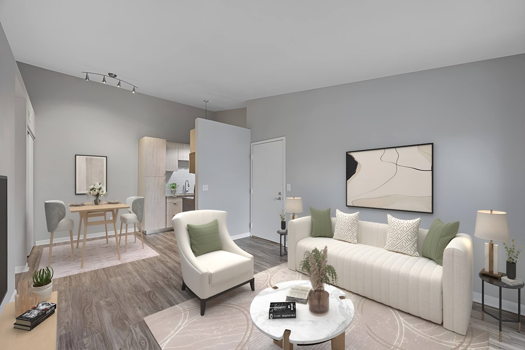 A living room with a white sofa, a white armchair, a wooden coffee table, and a painting on the wall. at The Reserve at Grand Valley Apartments, Milford, 45150