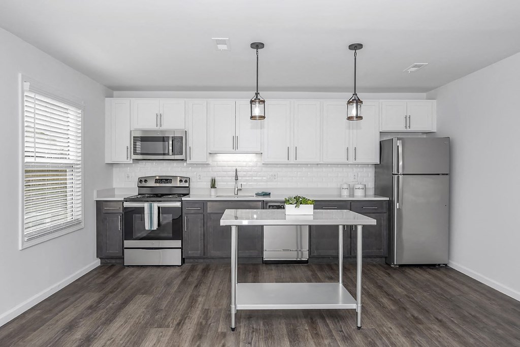 a kitchen with stainless steel appliances and white cabinets