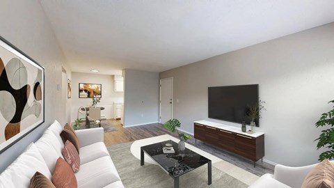 A modern living room with a white sofa, a black coffee table, and a large painting on the wall.