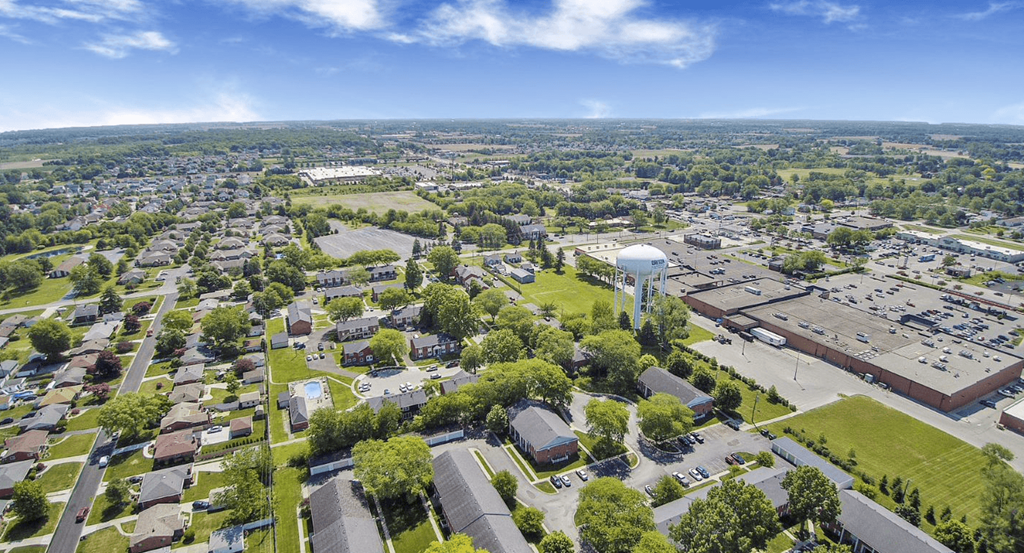 an aerial view of a city with a water tower in the middle of it