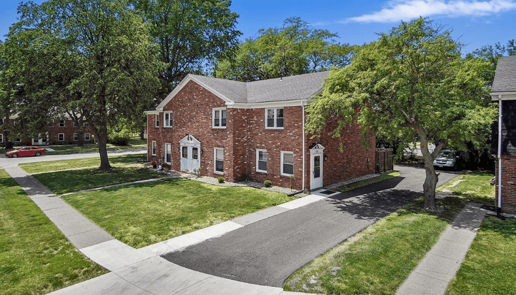 a red brick house with a gray roof