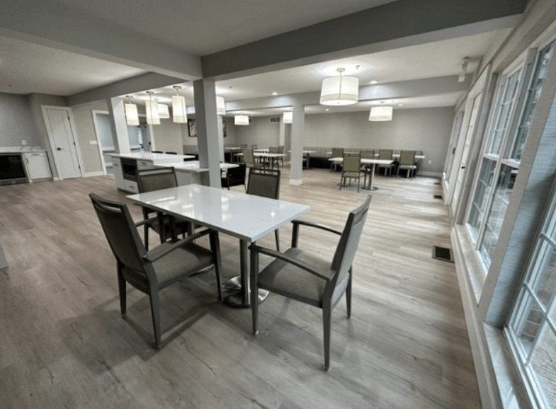 a dining area with a table and chairs