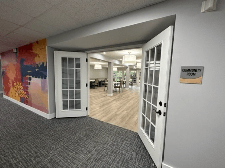 an open door leading into a room with a colorful mural on the wall