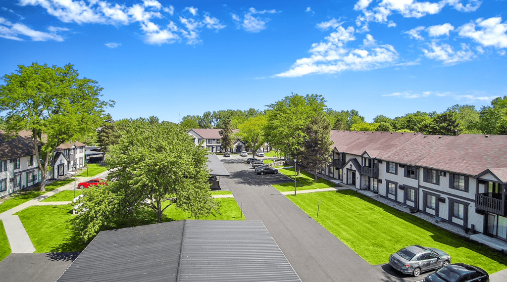 a view of a street with houses and lawns