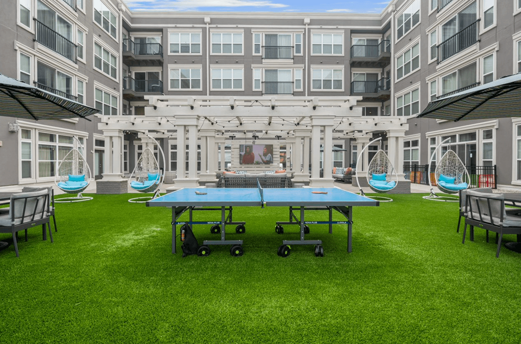 a ping pong table in front of an apartment building