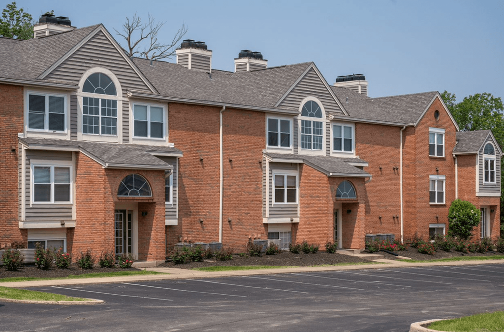 Large brick apartment building with a parking lot in front of itat Indian Lookout, Ohio
