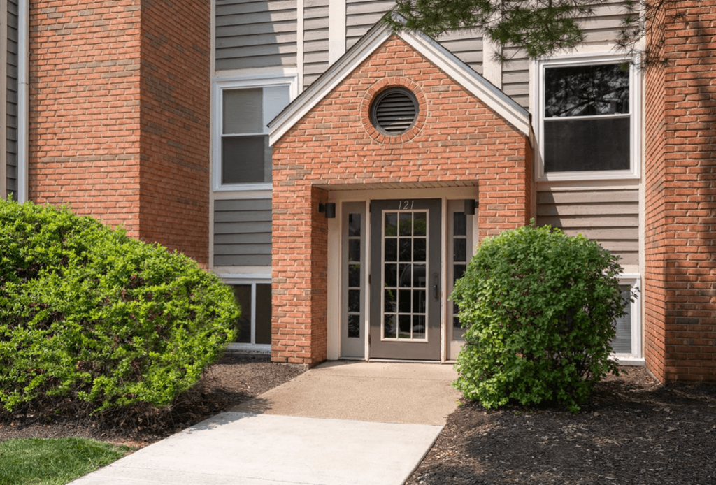 Walkway leads to a brick building with gray siding at Indian Lookout, Ohio