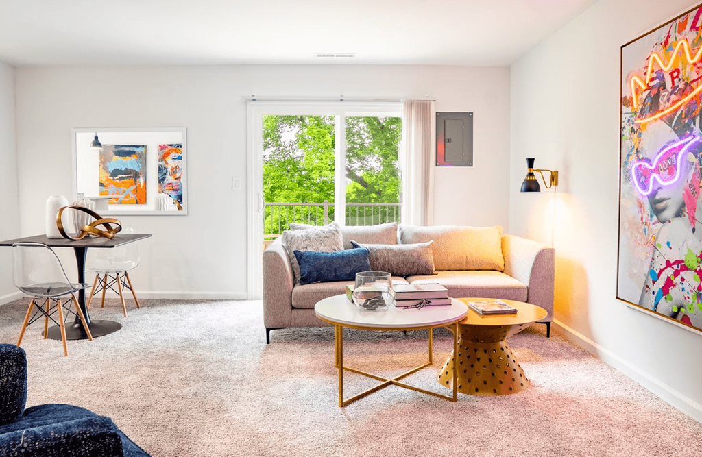 a living area with a couch coffee table and a desk with a chair
