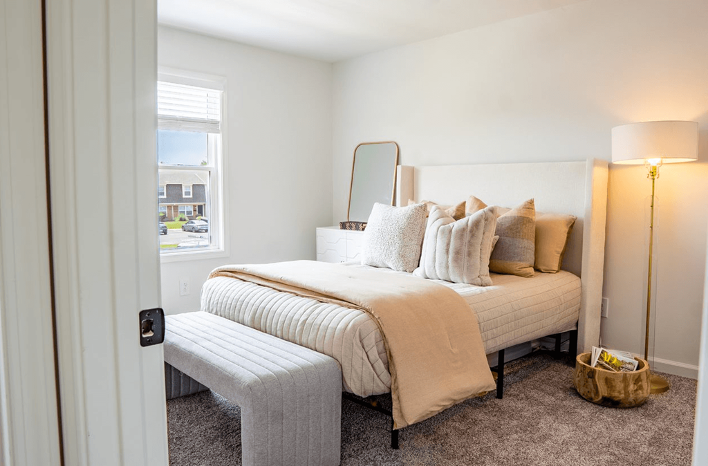 a bedroom with a bed and a chair in a 555 waverly unit