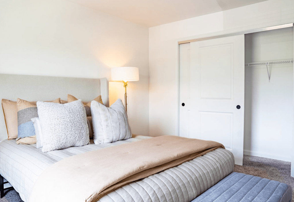 a bedroom with a bed and a closet