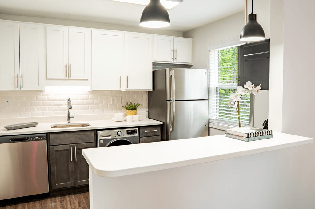 a kitchen with white cabinets and stainless steel appliances