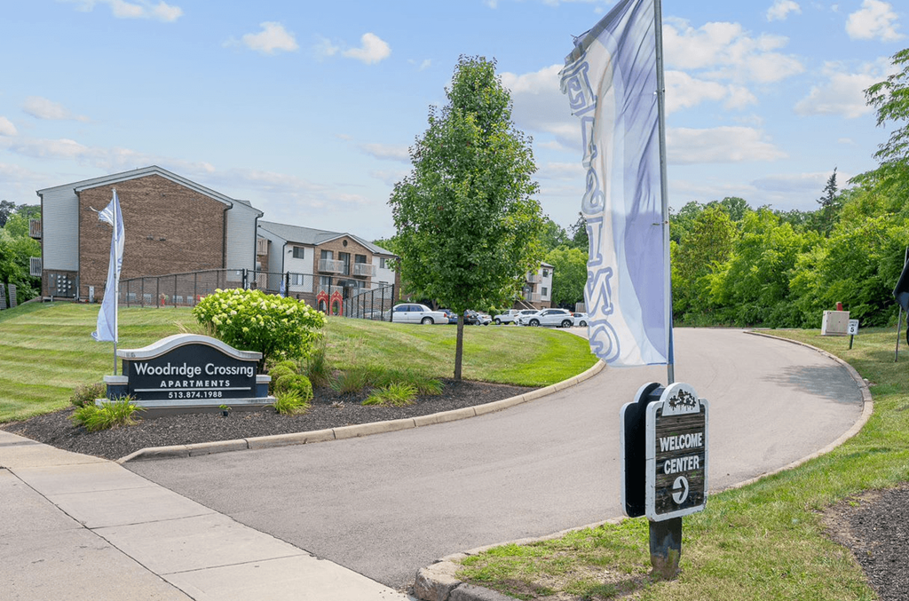a building with a sign that reads woodland commons with a mailbox in the foreground at The Woodridge Collection, Fairfield, OH