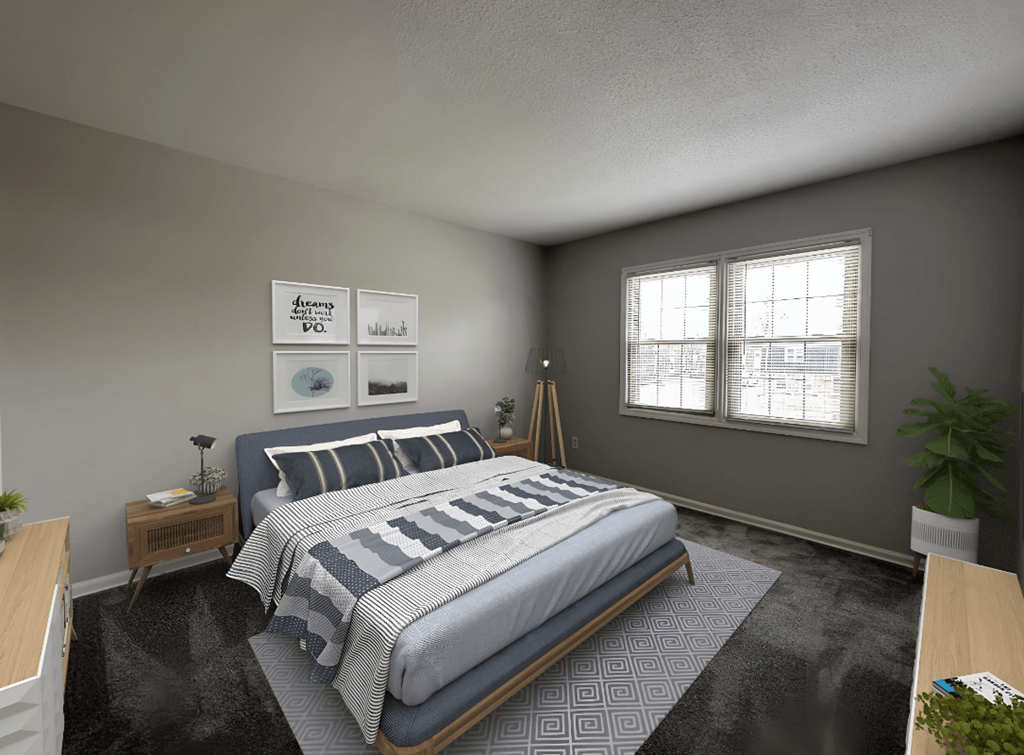 a bedroom with gray walls and a large bed with a blue and white comforter