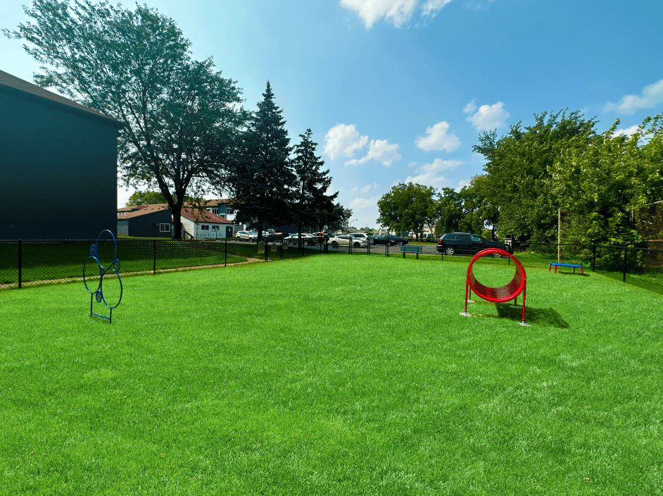 a large grassy area with a playground