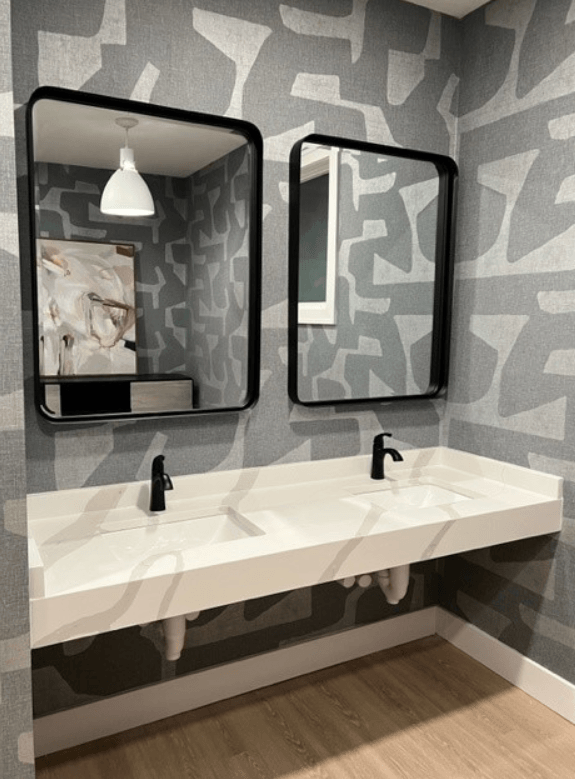 Bathroom with a gray and white wallpaper and two mirrors at Waterstone Landing, Perrysburg