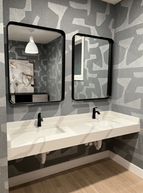 a bathroom with a gray and white wallpaper and two mirrors at Waterstone Landing, Perrysburg