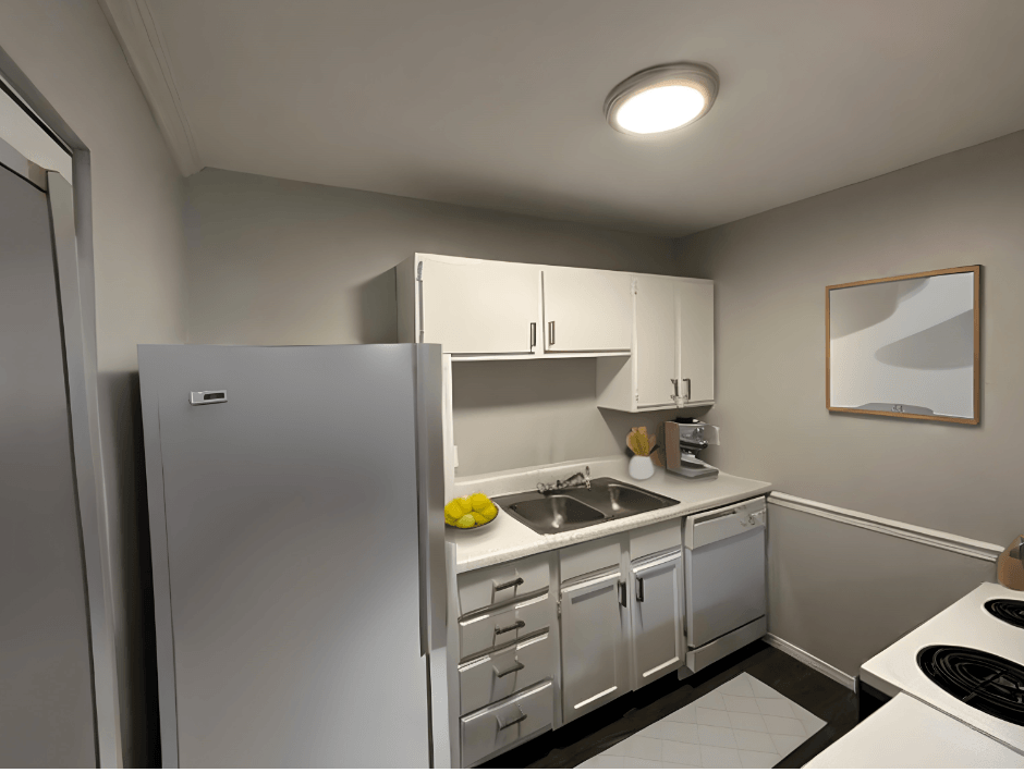 a small kitchen with white cabinets and a refrigerator