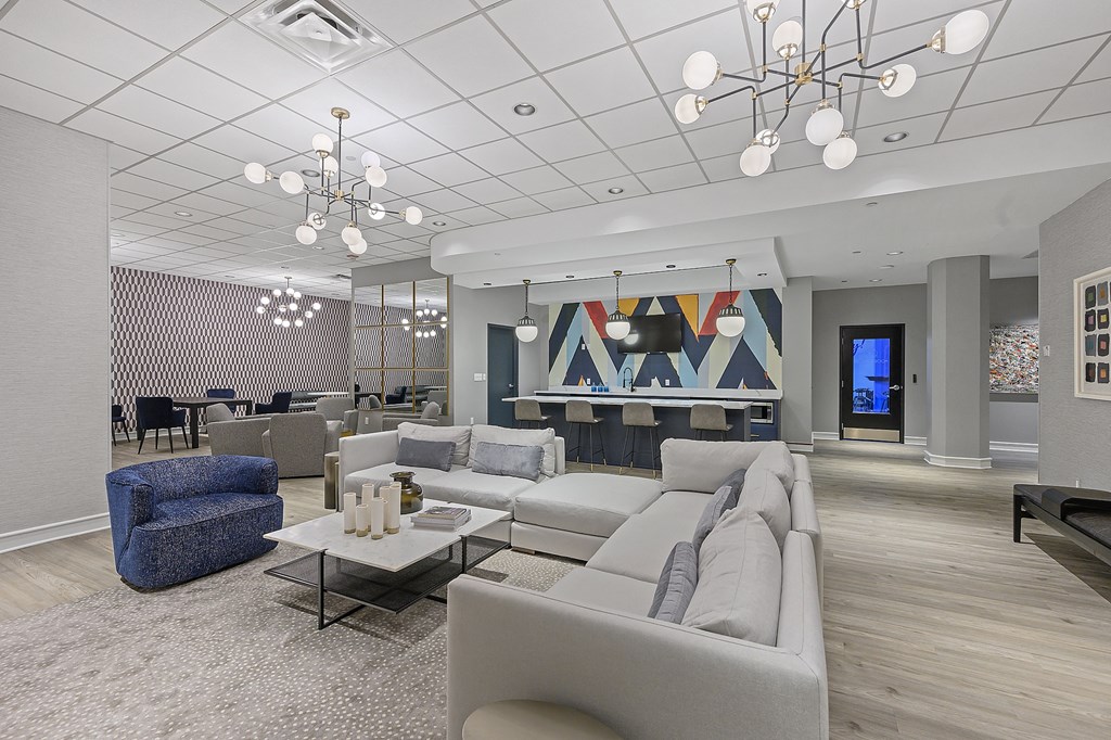 a large living room with couches and chairs and tables